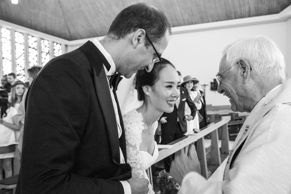 Hochzeitsreportage Kirche Freiburg Braut lächelt den Pfarer an